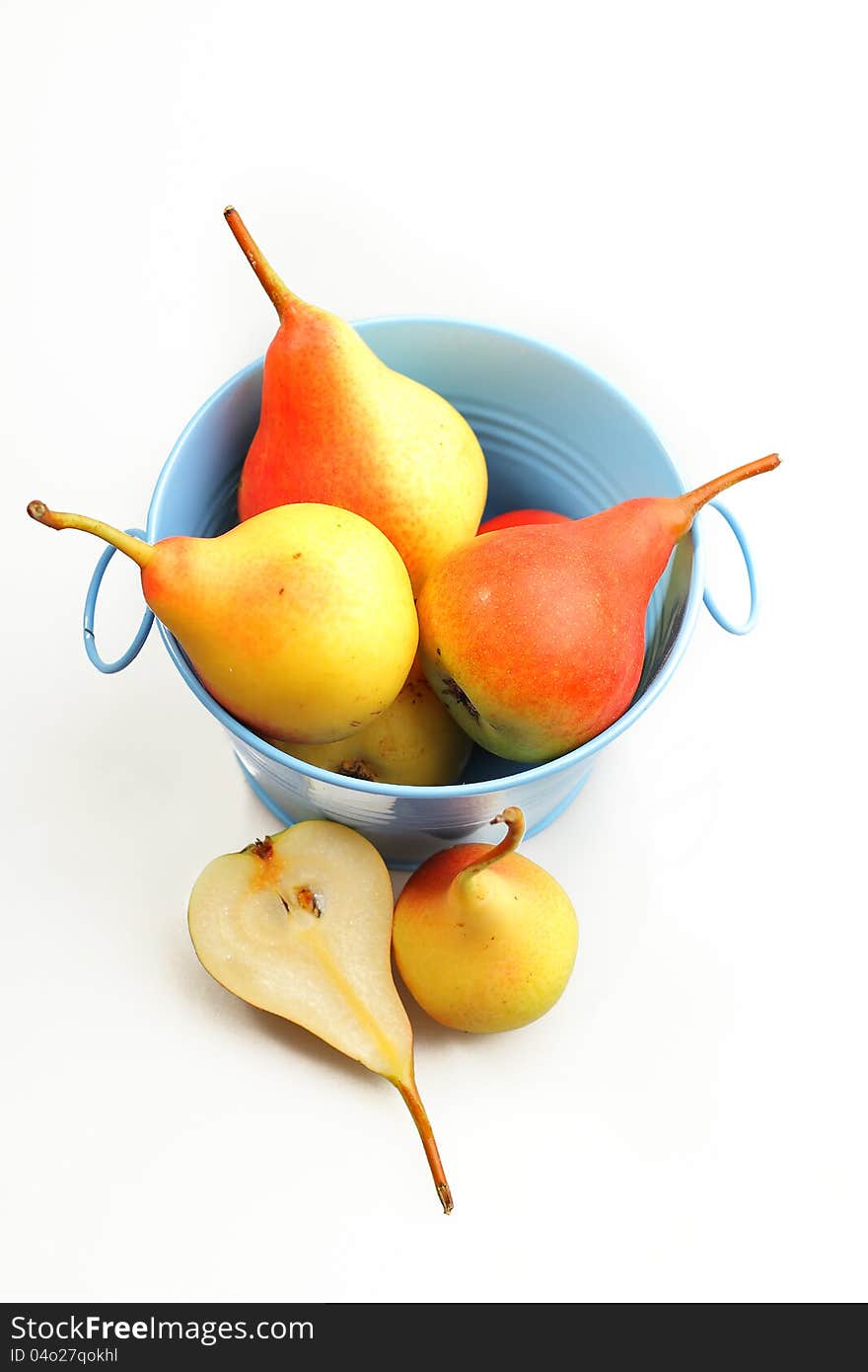 Fresh autumn pears in blue tin bucket