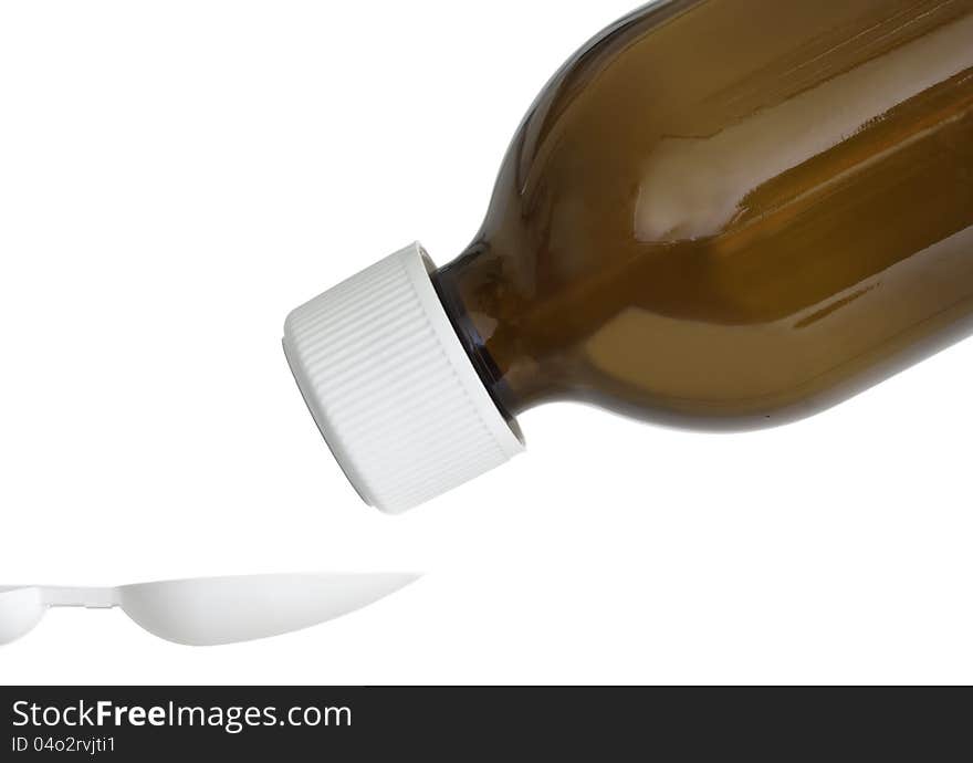 Macro shot of a generic cough syrup bottle pouring the medicine onto a special measuring spoon with the child safety cap still attached. Shot could be used to highlight the importance of keeping medicines safe and out of childs reach. Macro shot of a generic cough syrup bottle pouring the medicine onto a special measuring spoon with the child safety cap still attached. Shot could be used to highlight the importance of keeping medicines safe and out of childs reach.