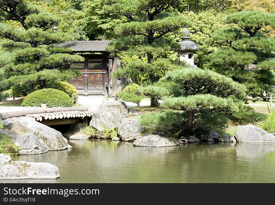 A picturesque Japanese garden with a beautiful pond. A picturesque Japanese garden with a beautiful pond.