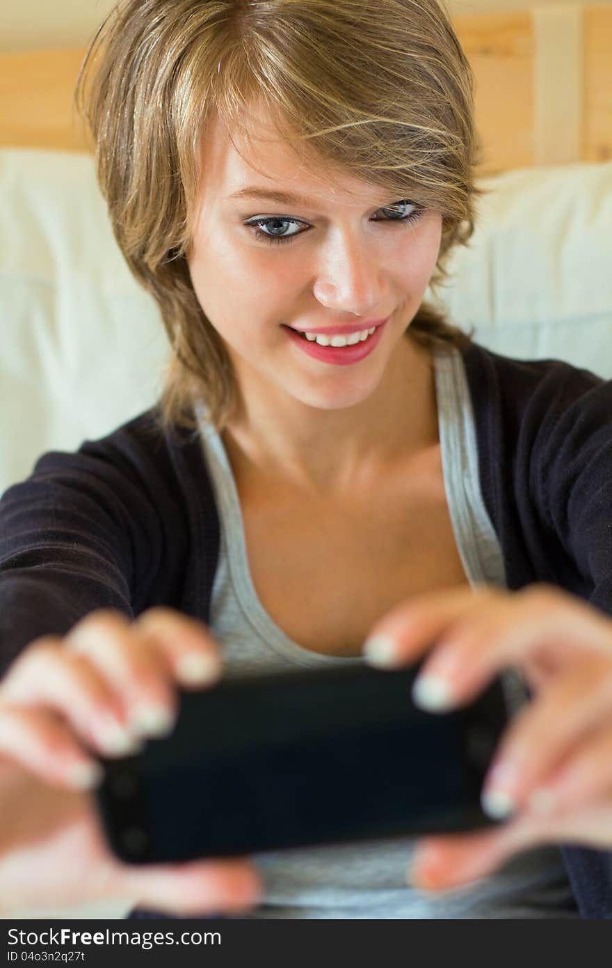 Blonde woman taking a picture of her on the mobile