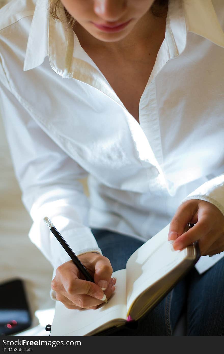 Young blonde woman taking notes. Young blonde woman taking notes