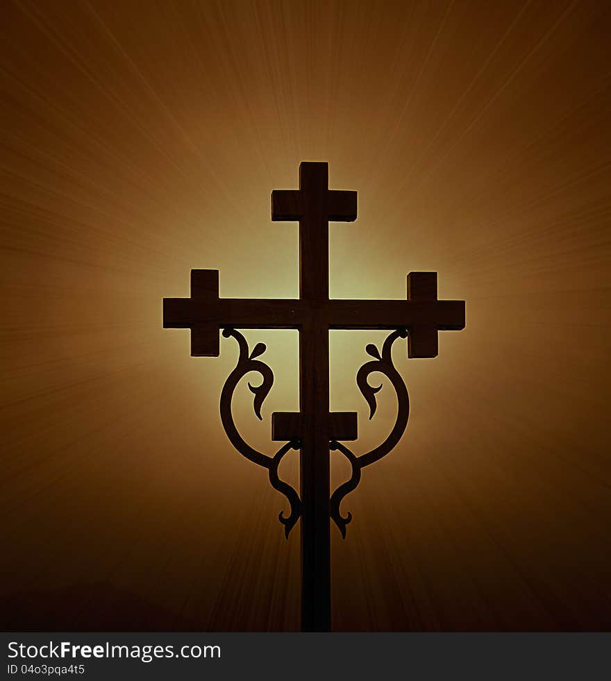 Highlighted shining cross cross on a dark background. Highlighted shining cross cross on a dark background