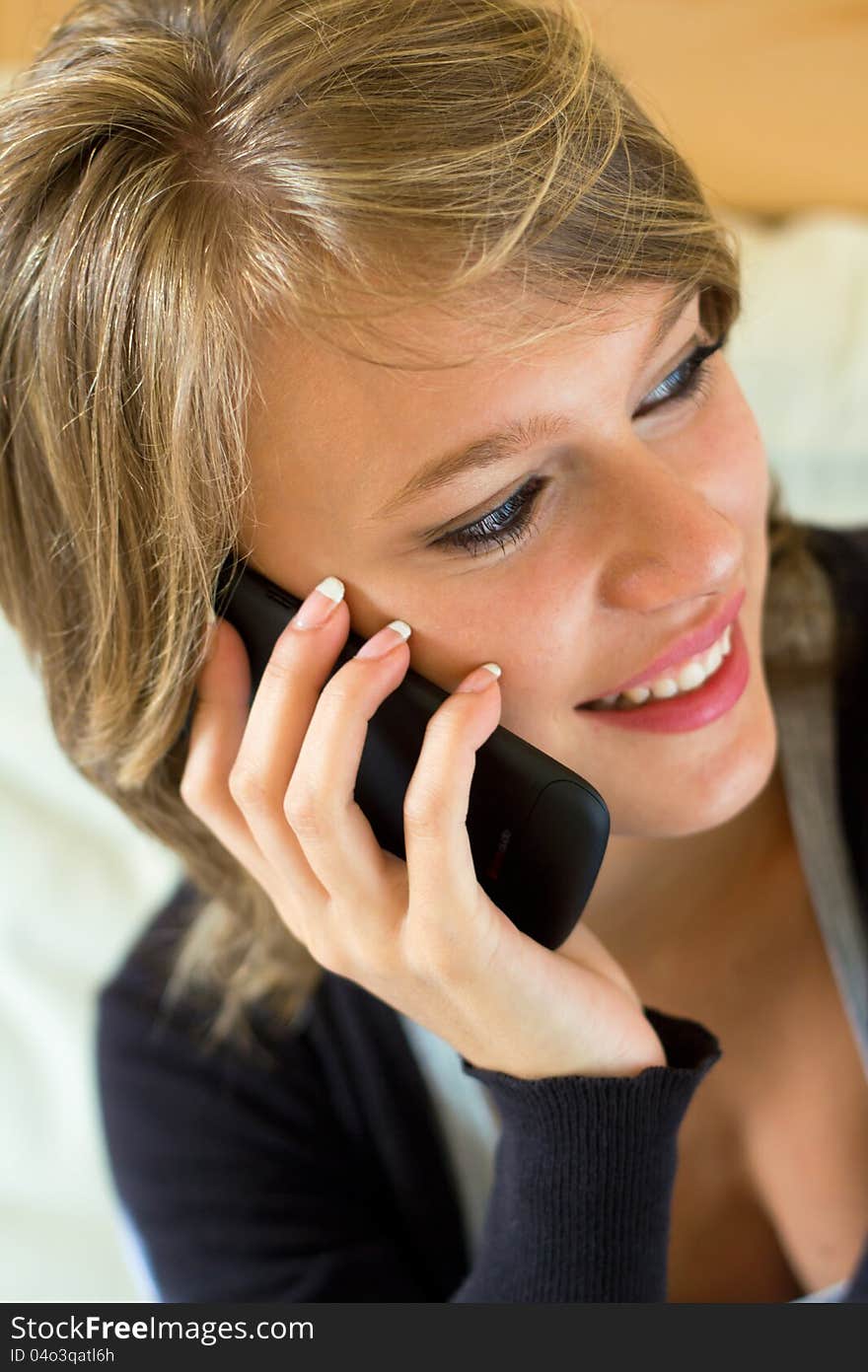 Blonde Woman With Mobile At Home