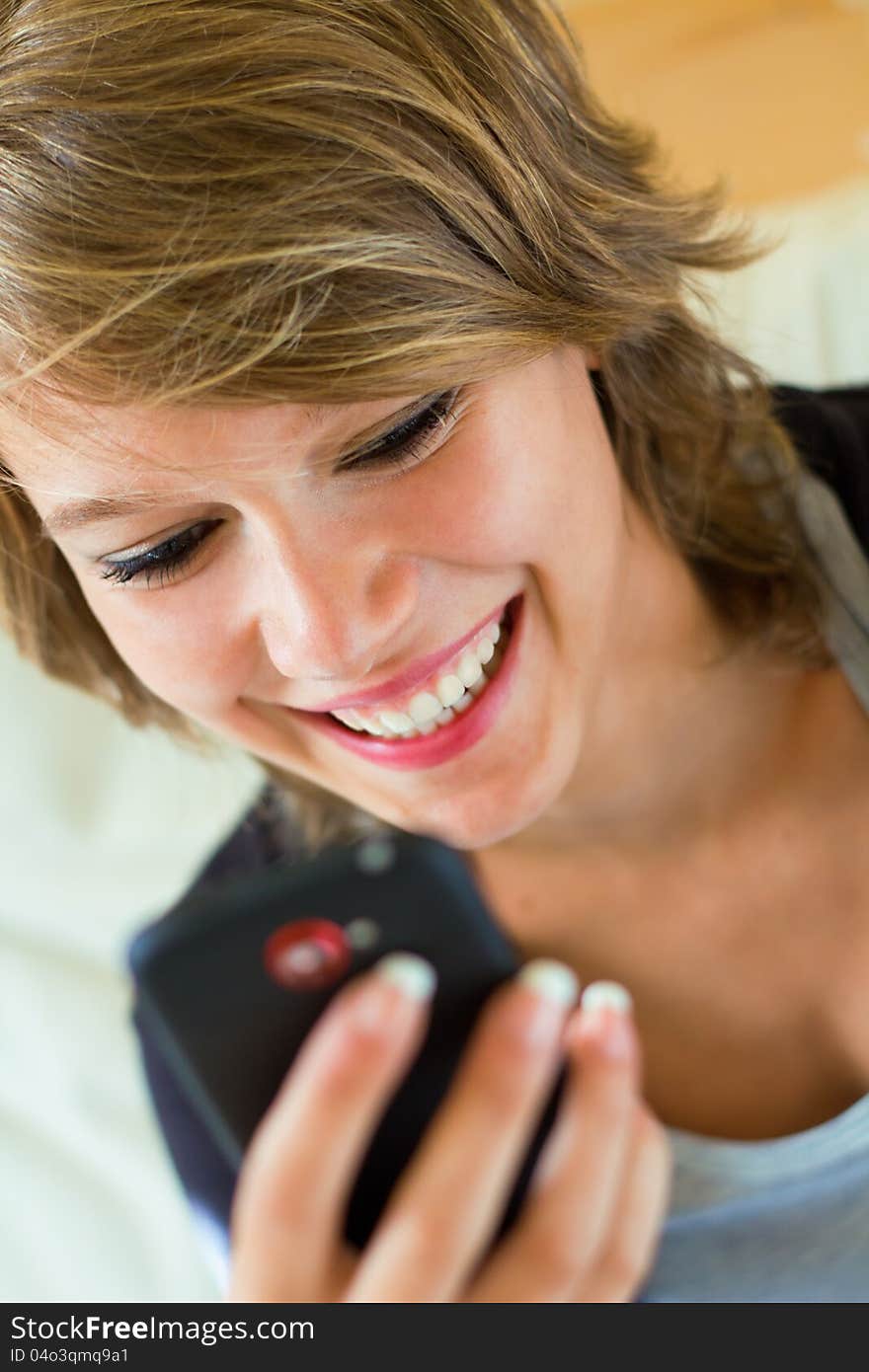 Blonde woman with mobile at home