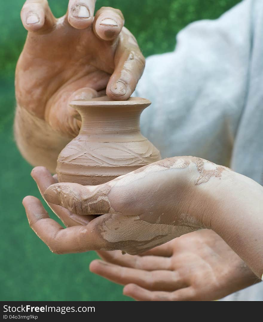 Hand holding pottery an  jar