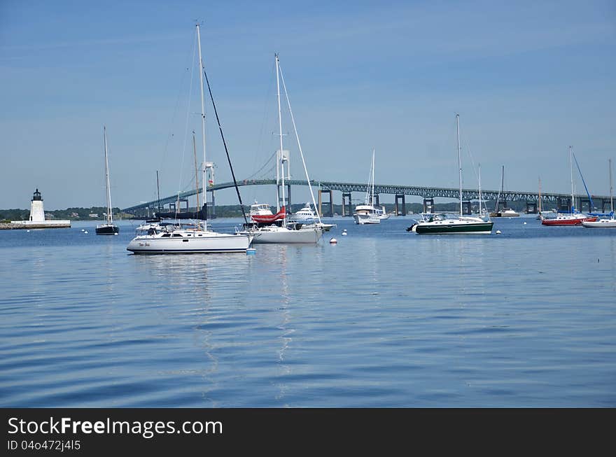 A background with blue water and blue sky and several boats in the island Newport