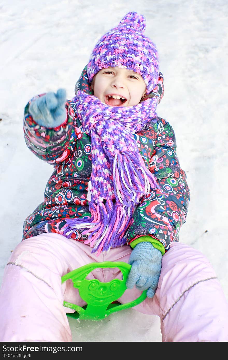 Girl Rolls Down Hill In Winter Park