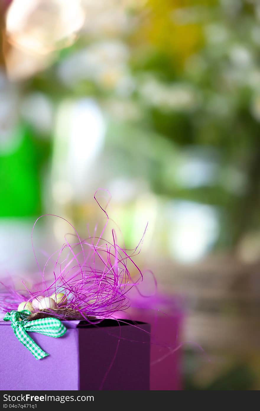 Purple gift box close-up with blurred abstract background