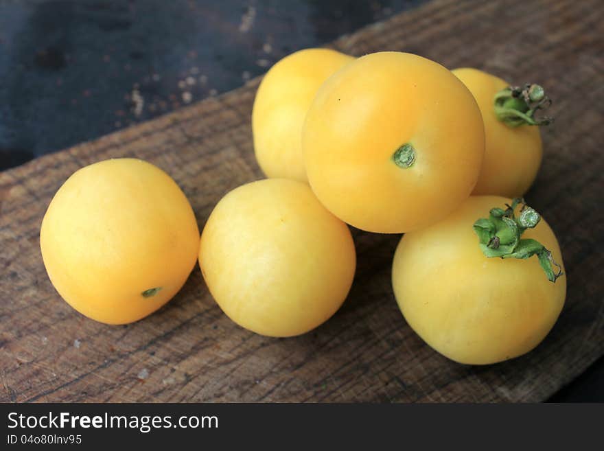 Beautiful Yellow Tomatoes On A Wooden Background