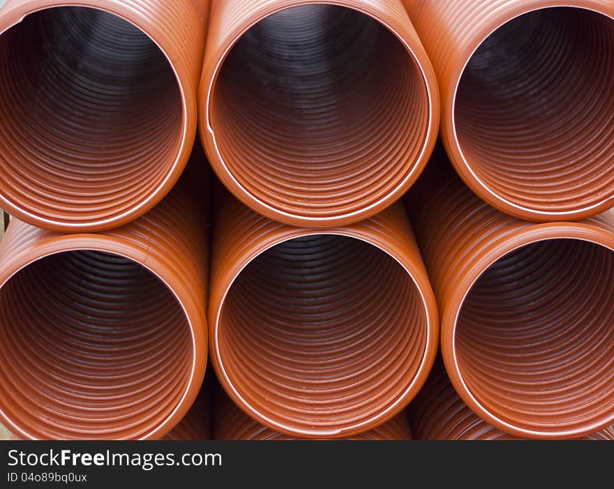 Orange discharge sewage pipes in the ground