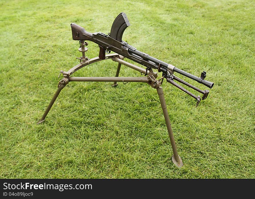 A Vintage Military Machine Gun on a Tripod Stand. A Vintage Military Machine Gun on a Tripod Stand.