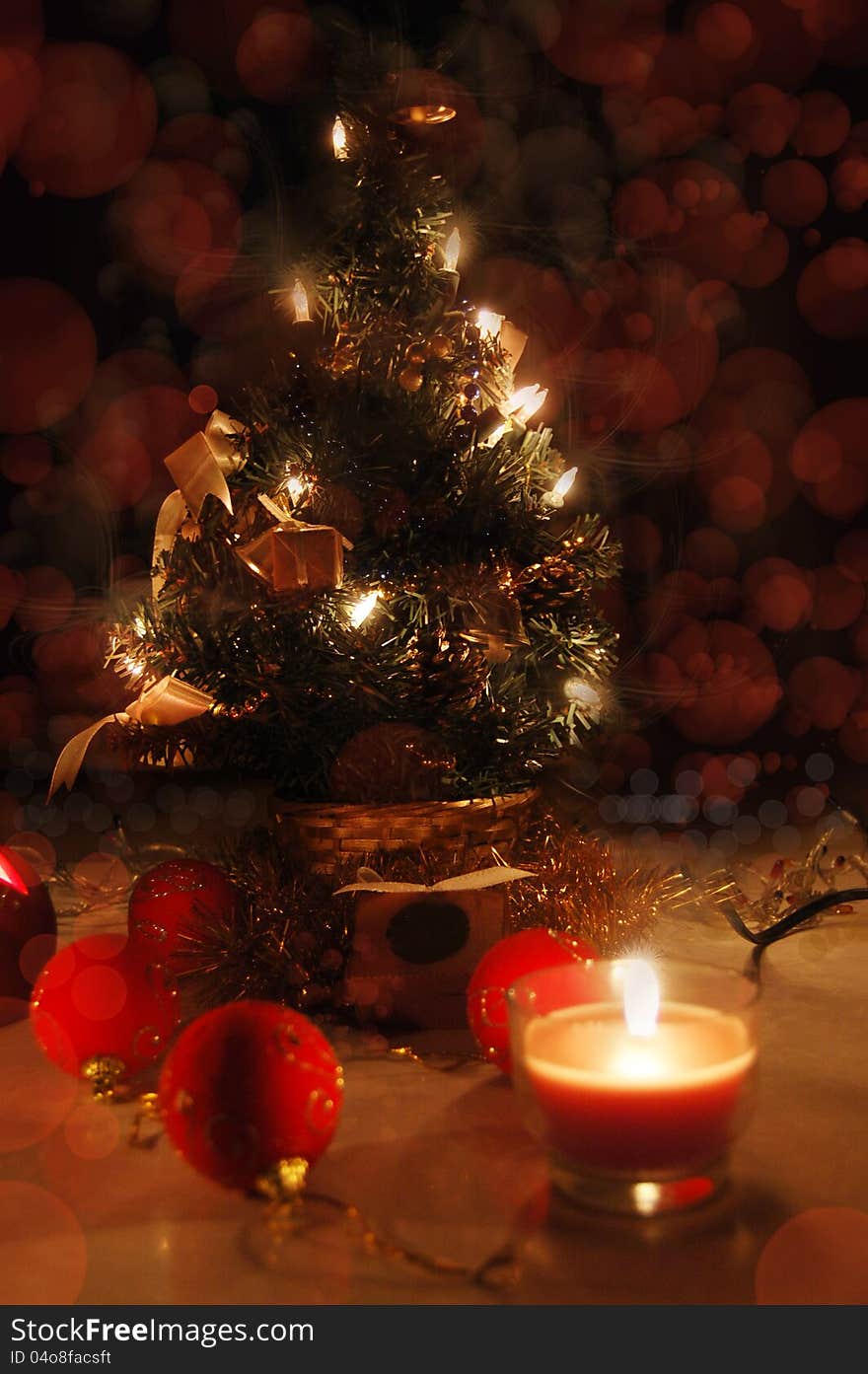 Christmas tree with lights and candles over black, tree in focus