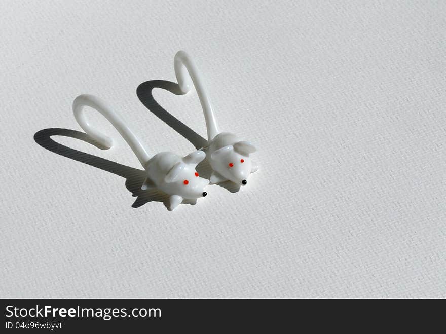 Two mice from white glass with heart-shapen shadow. Two mice from white glass with heart-shapen shadow.