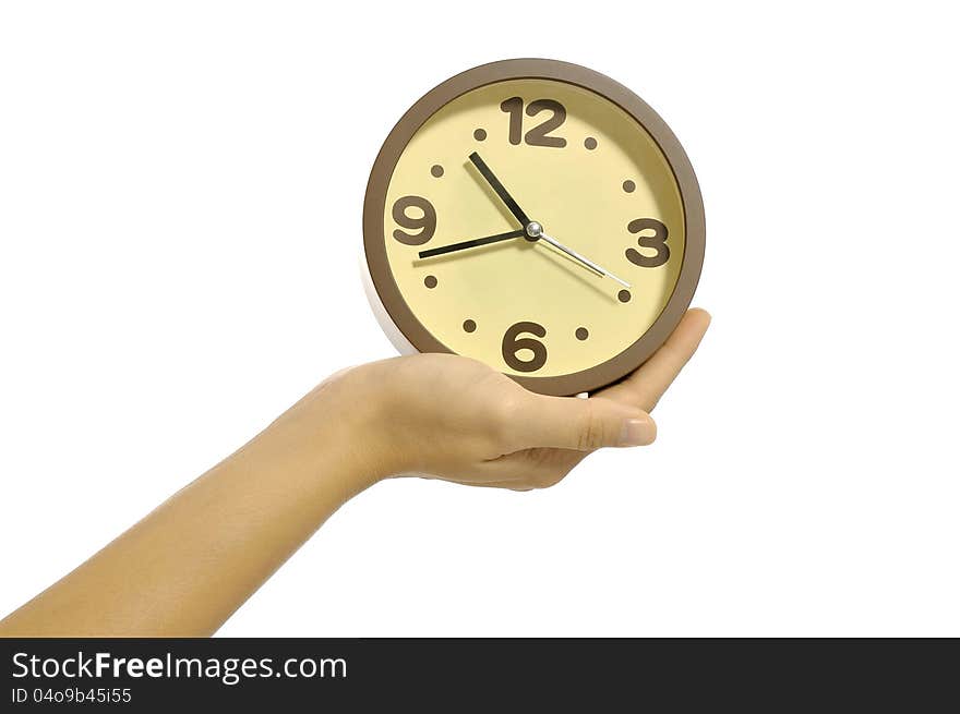 Hand holding clock isolated over white background. Overtime concept