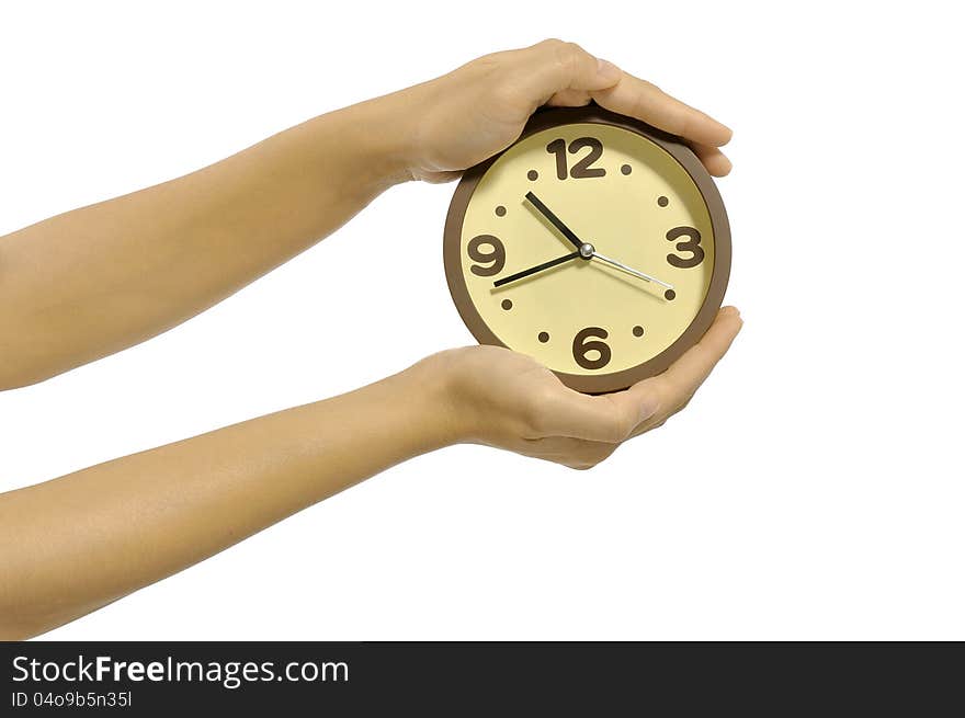 Hand holding clock isolated over white background. Overtime concept