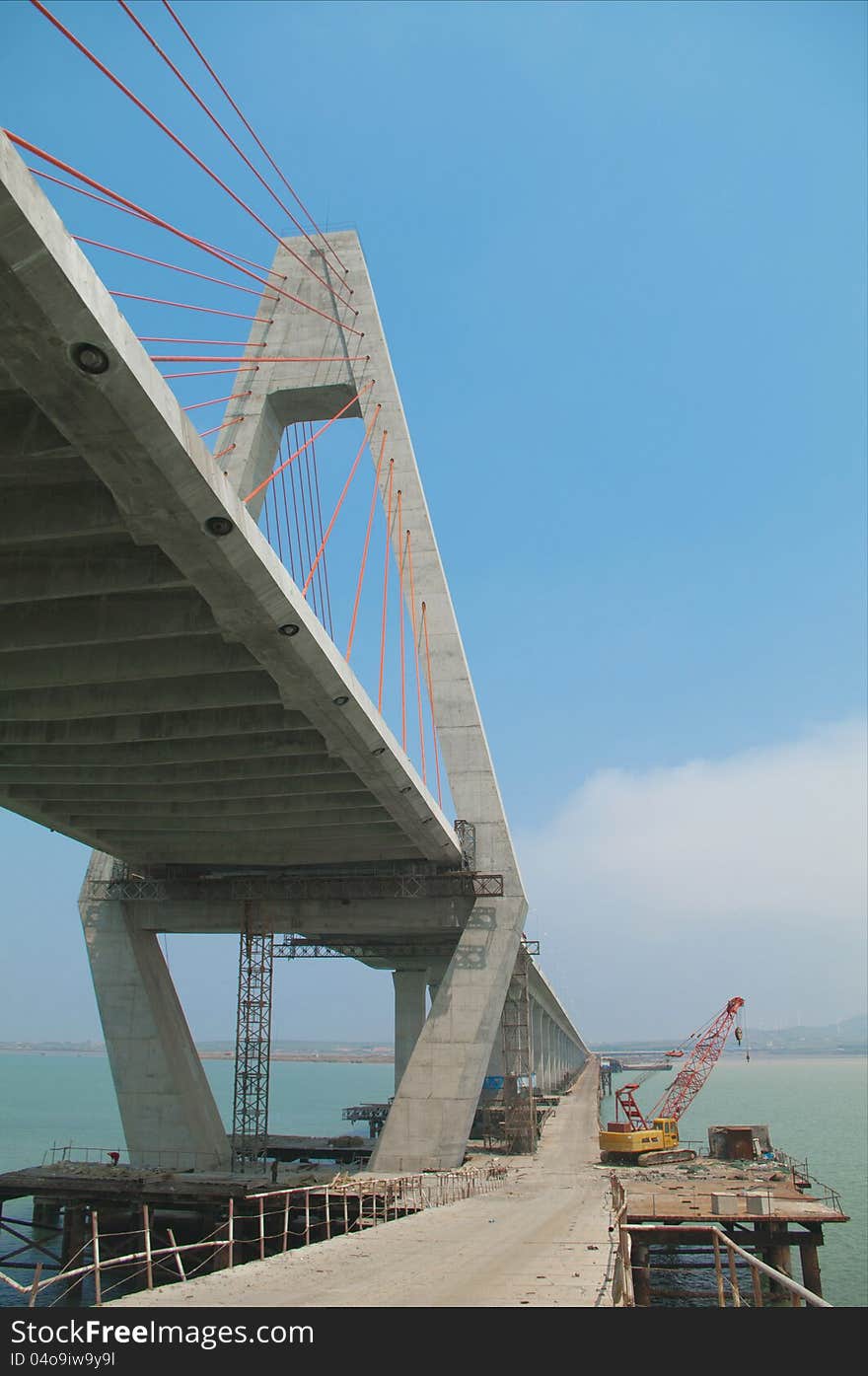 Construction of cross-sea bridge  from a low point of view. Construction of cross-sea bridge  from a low point of view