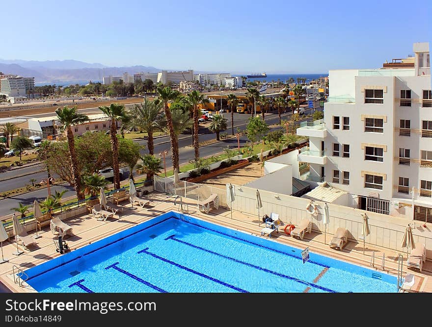 Beautiful view of the pool, palm avenue and modern hotels in the Red Sea resort. Eilat, Israel. Beautiful view of the pool, palm avenue and modern hotels in the Red Sea resort. Eilat, Israel