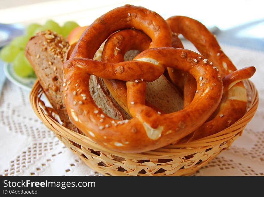 A basket of Freshly baked Bavarian Pretzel (Brezel) and other types of bread. A basket of Freshly baked Bavarian Pretzel (Brezel) and other types of bread