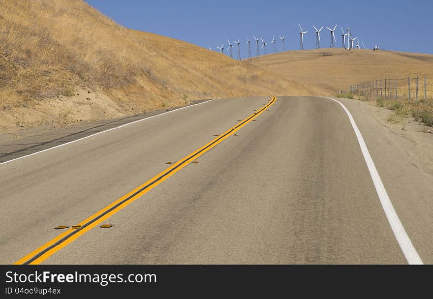 A California side road leads to a sizable wind farm. A California side road leads to a sizable wind farm