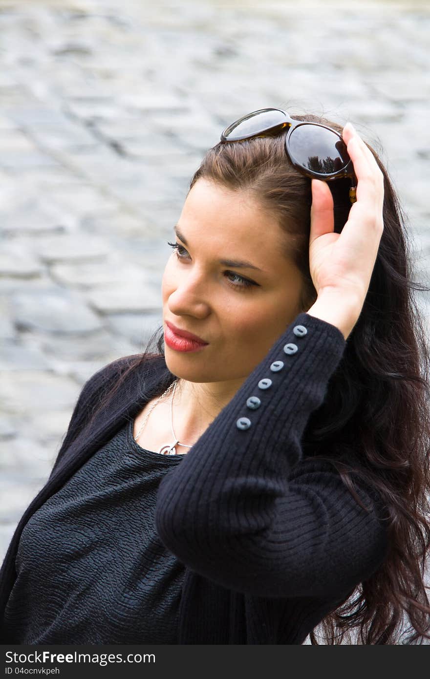 A beautiful woman, with sunglasses on her head, reaching up to take them. A beautiful woman, with sunglasses on her head, reaching up to take them.