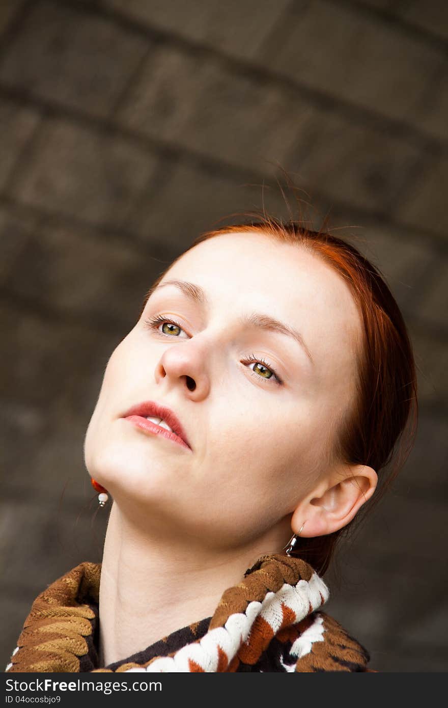 Portrait of a beautiful woman, with eyes half closed, with brick background. Portrait of a beautiful woman, with eyes half closed, with brick background.