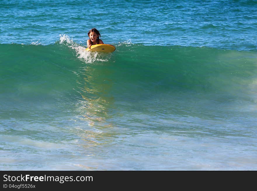 Surfing girl on a wave