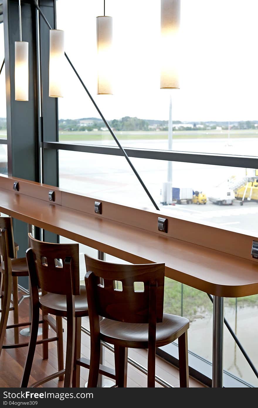 Details of the counter and empty chairs in simple modern bar. Details of the counter and empty chairs in simple modern bar.