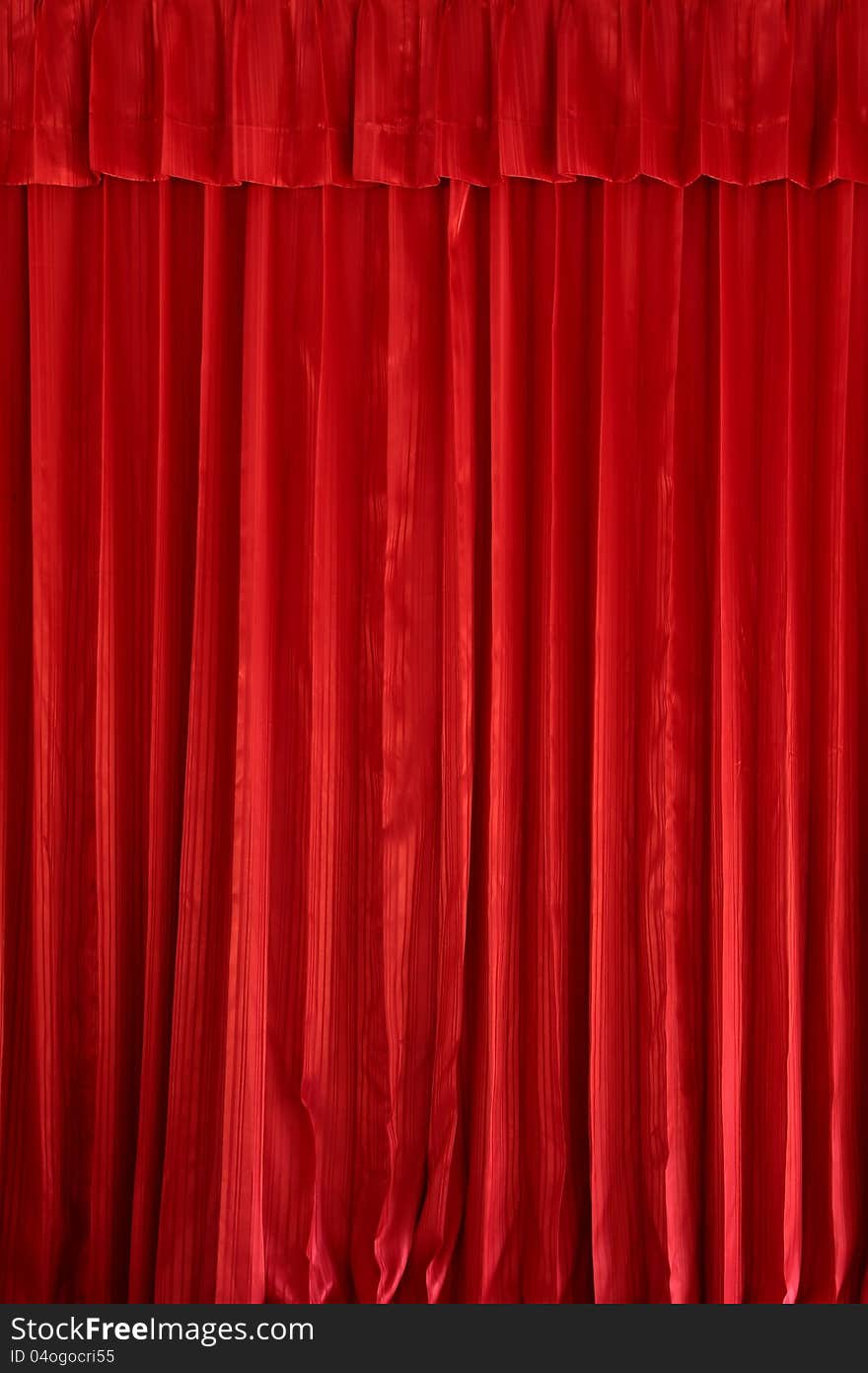 Vertical a red curtain texture is decoration background. Vertical a red curtain texture is decoration background