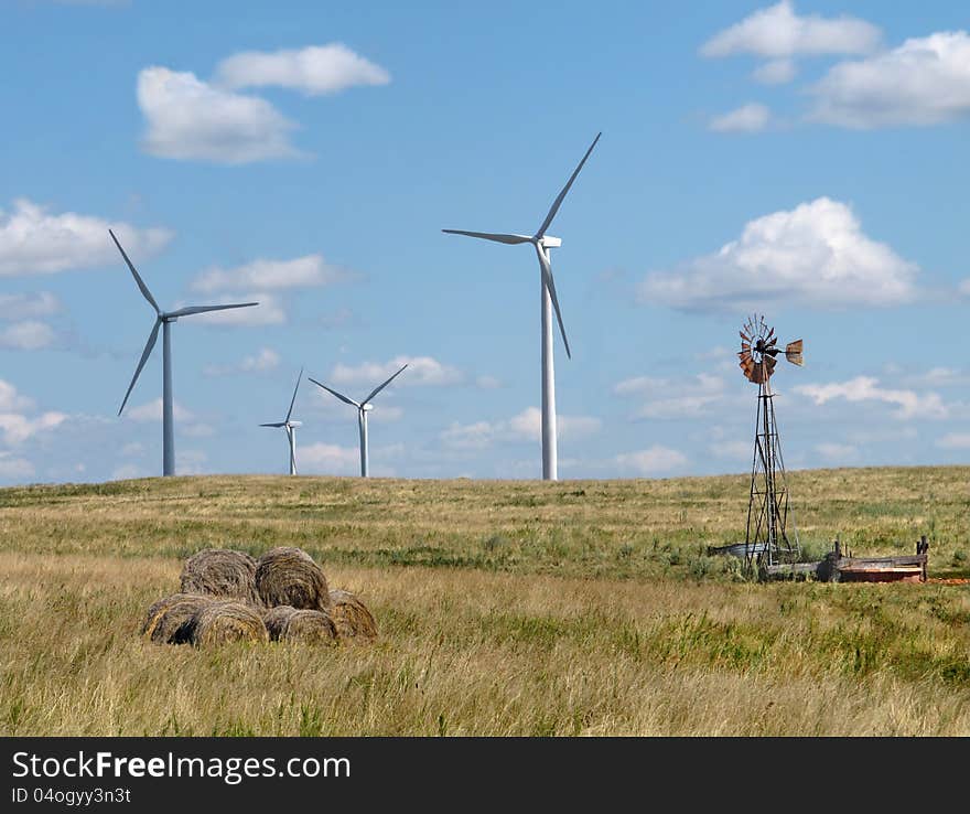 Old And New Windmills In A Rural Pasture