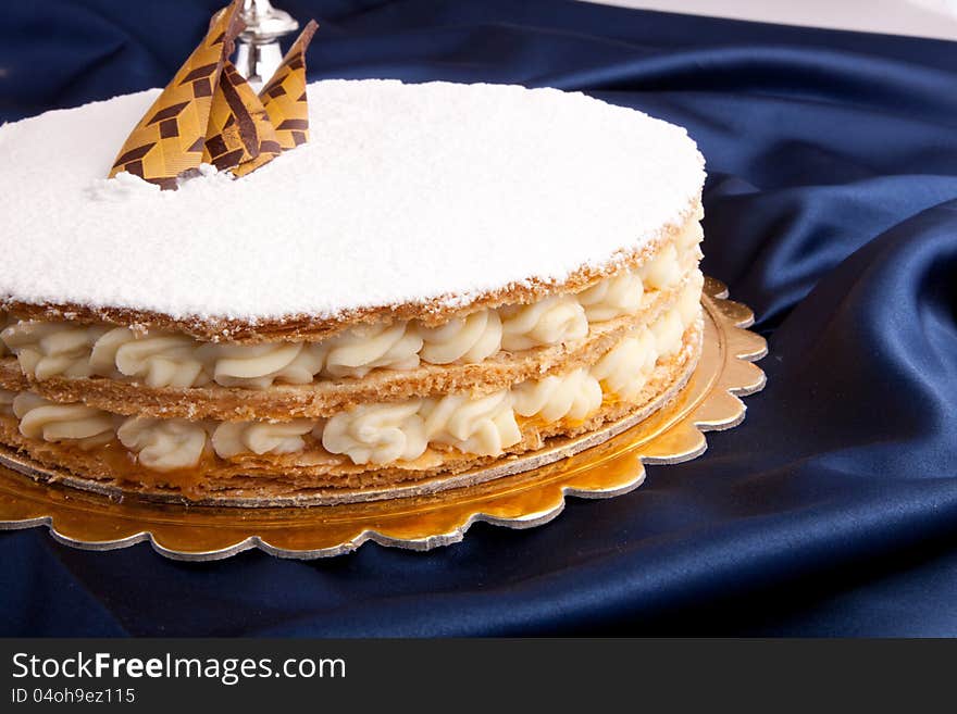 White Sugar Cake on blue with tow red candles in candlestick