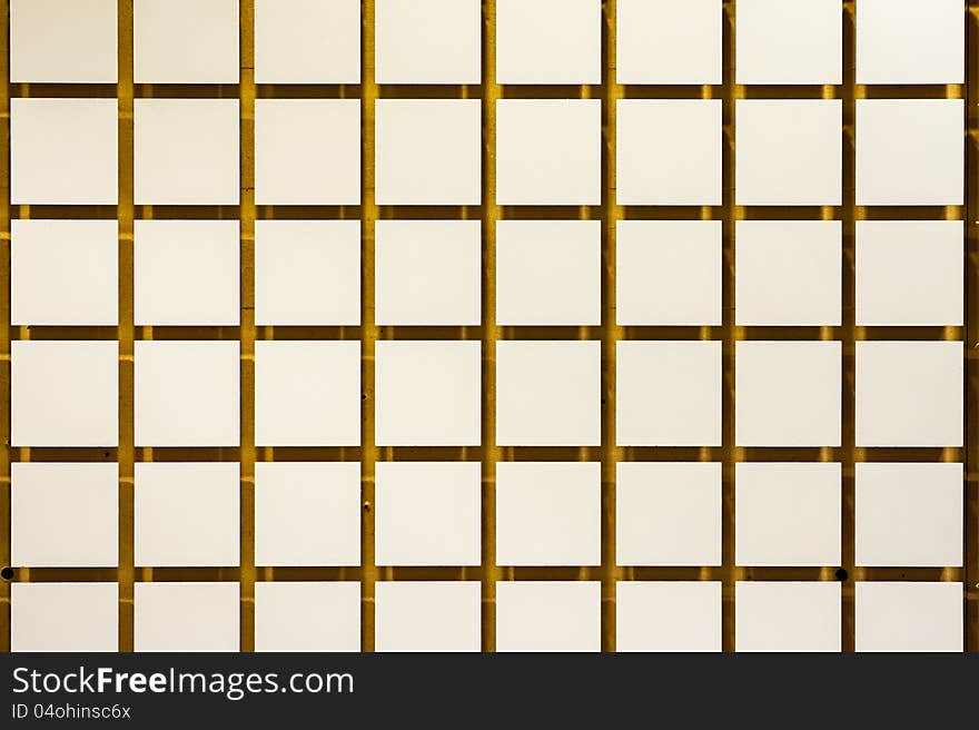 Wall of small squares raised off a yellow backdrop. Wall of small squares raised off a yellow backdrop.