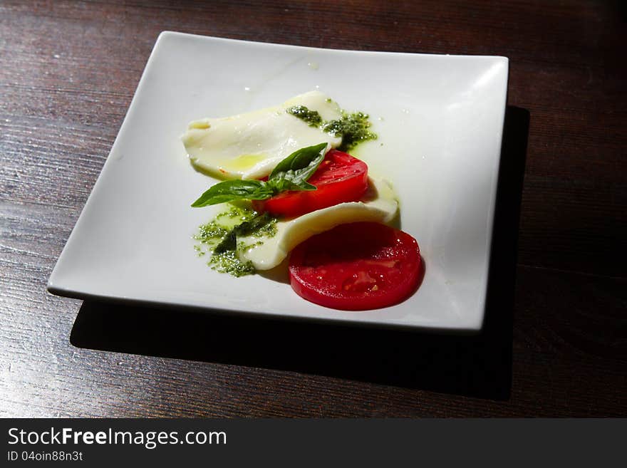 Cheese and tomatoes are on a plate