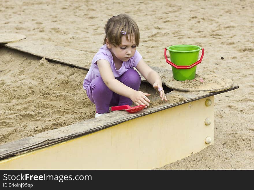 Sweet little girl playing in the sandbox. Sweet little girl playing in the sandbox