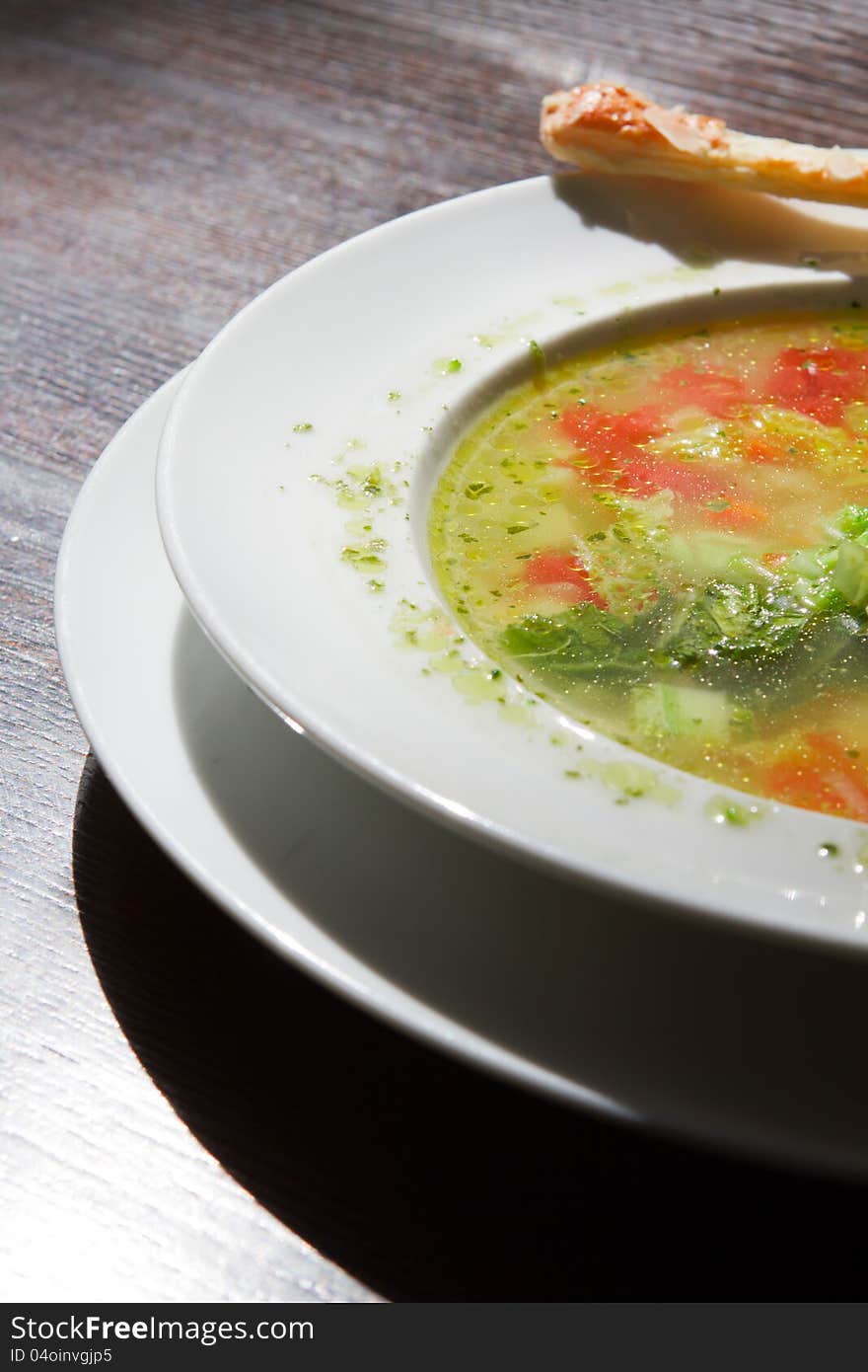 Soup in a plate on the table. macro