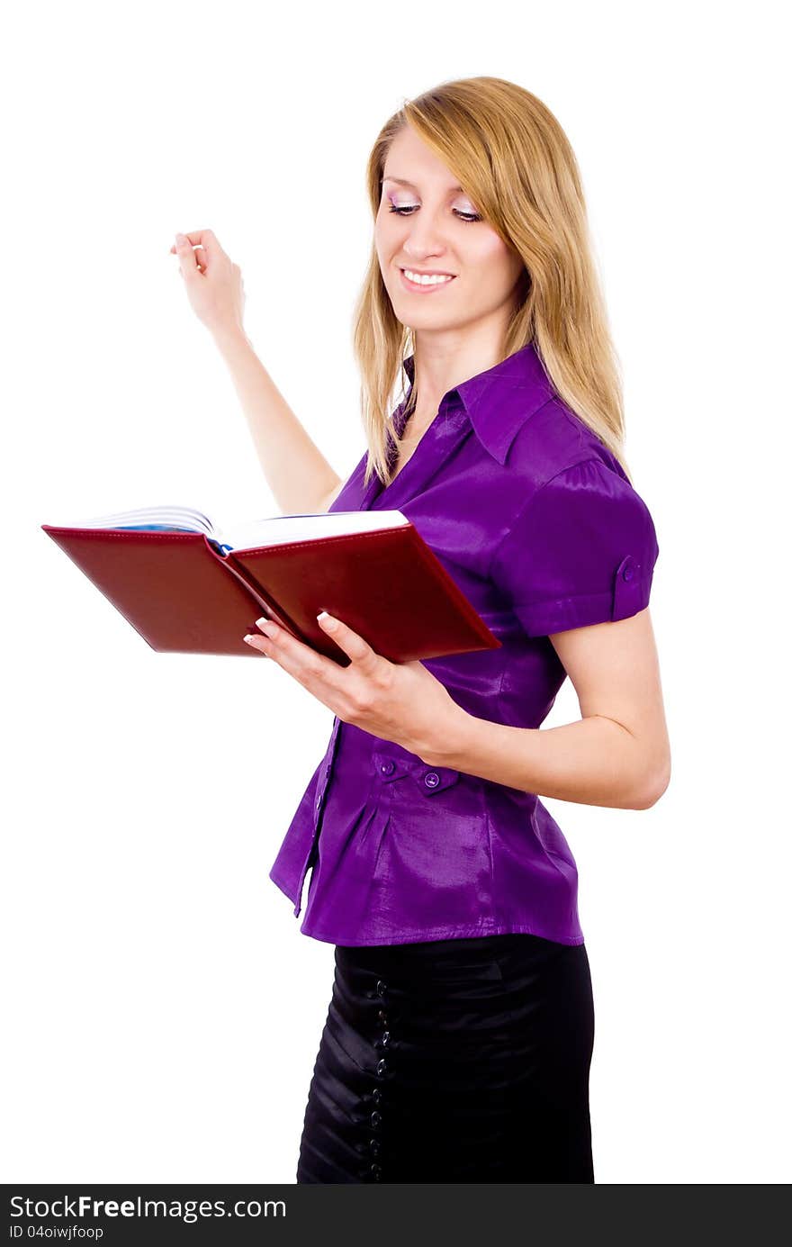 The girl keeps a book and indicates isolated on white background