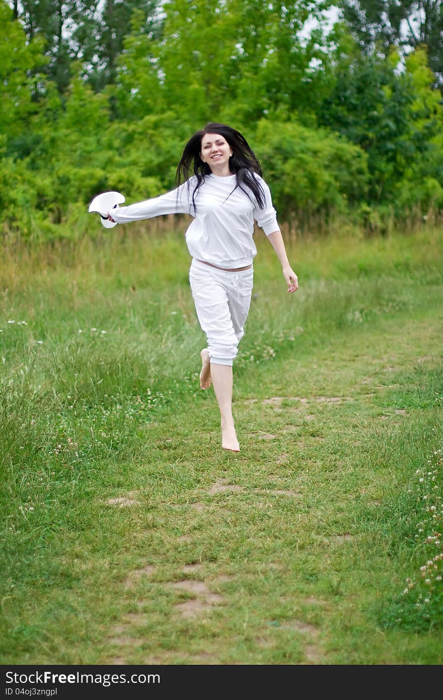 Happy woman running on the path