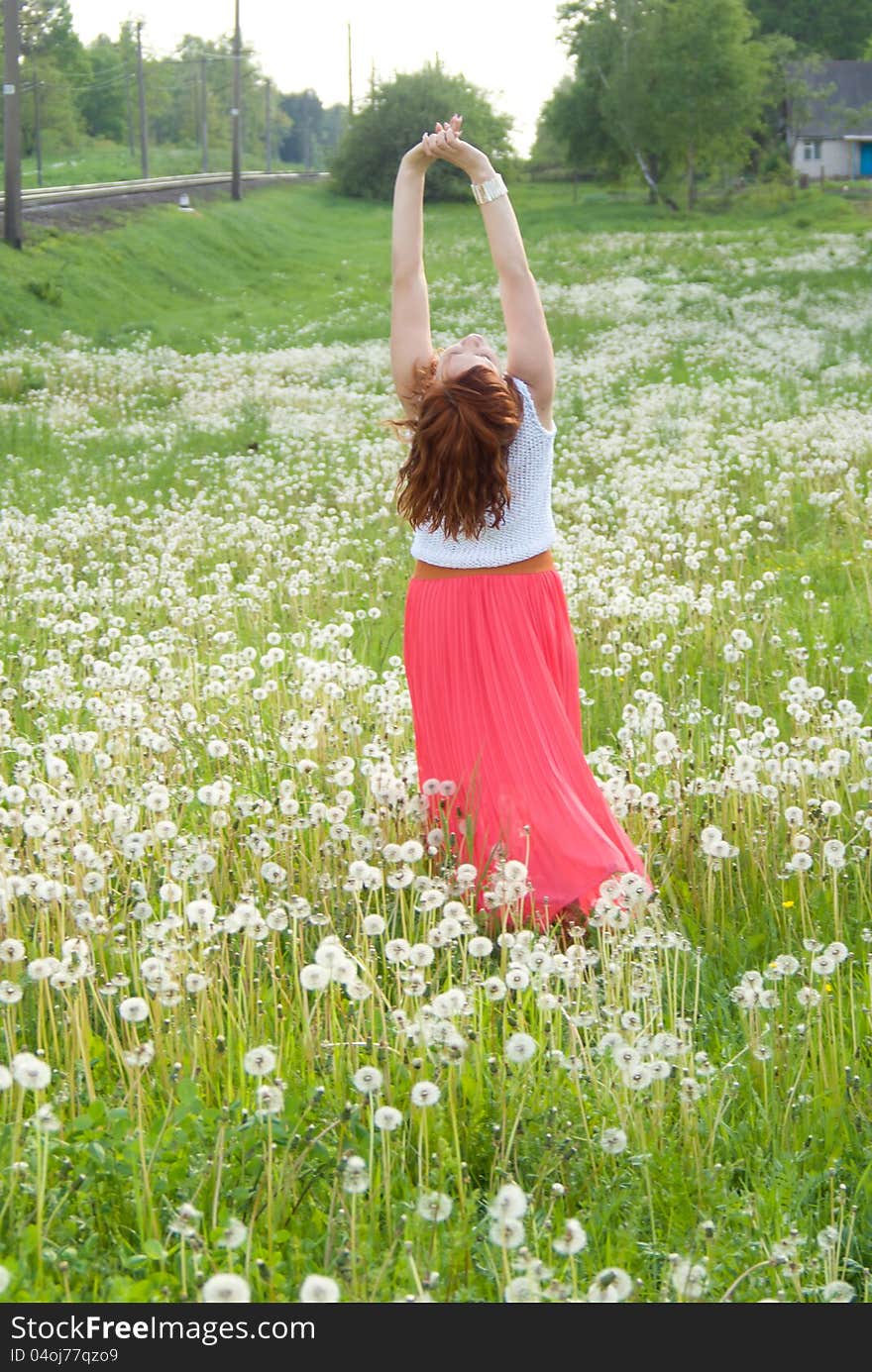 Beautiful girl standing on the field on nature