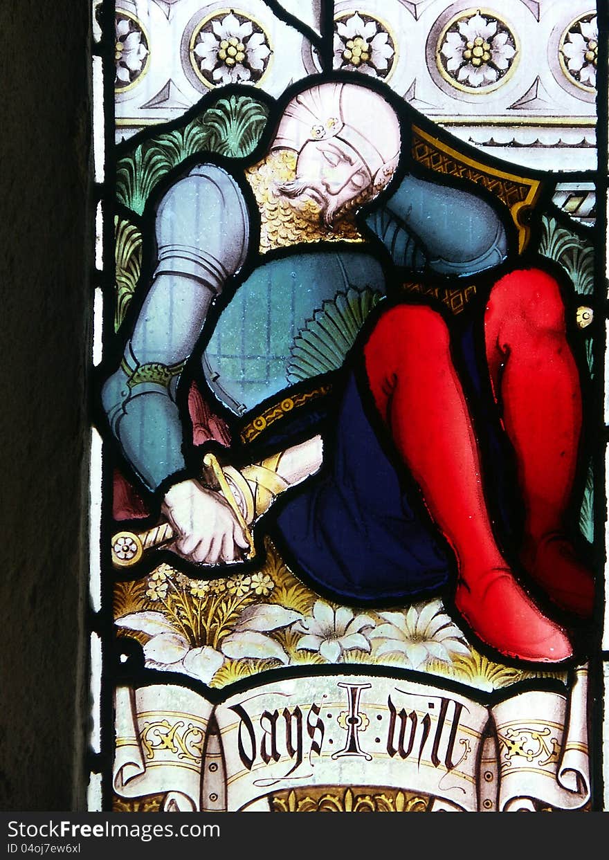 Section of stained glass window showing sleeping armoured soldier. Section of stained glass window showing sleeping armoured soldier