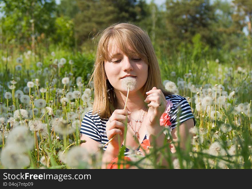 Beautiful Girl Lying On The Field In Dandelion