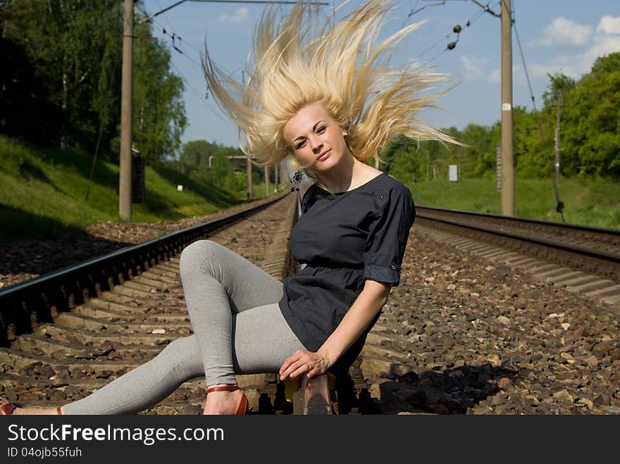 Girl Blonde Sitting On The Rails