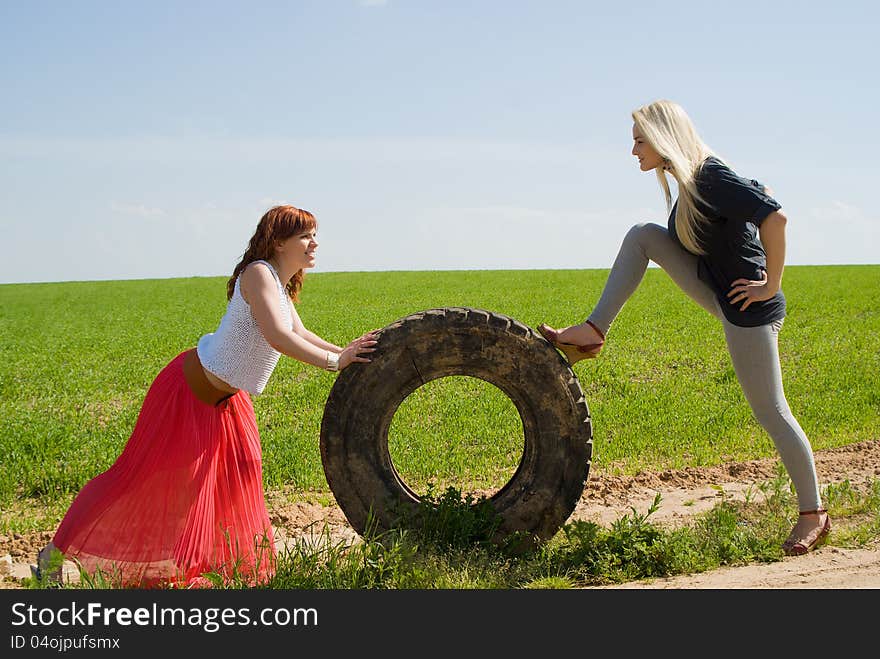 Two girls rolls wheel