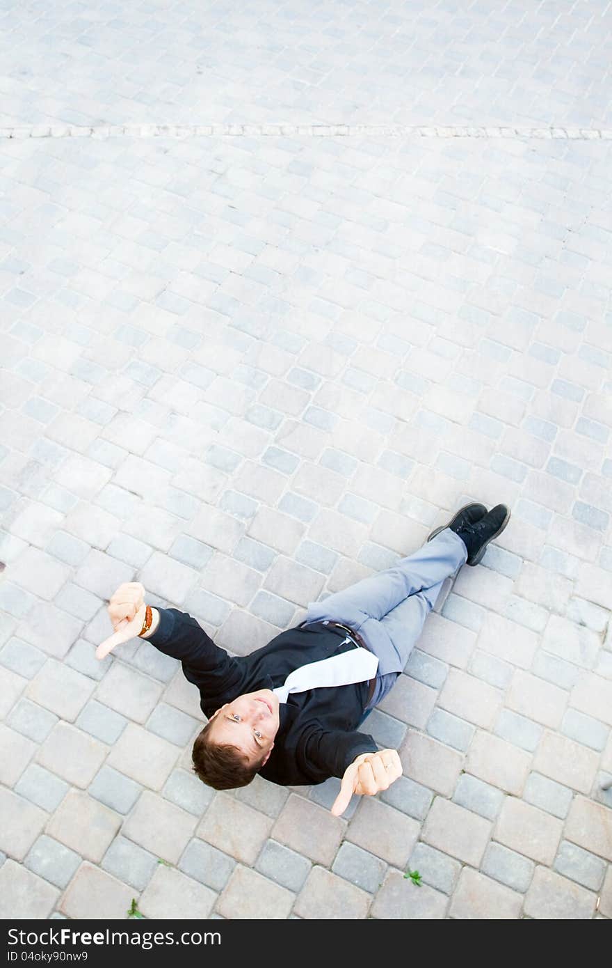 The image on top of a businessman sitting in the street, which has a success. The image on top of a businessman sitting in the street, which has a success.