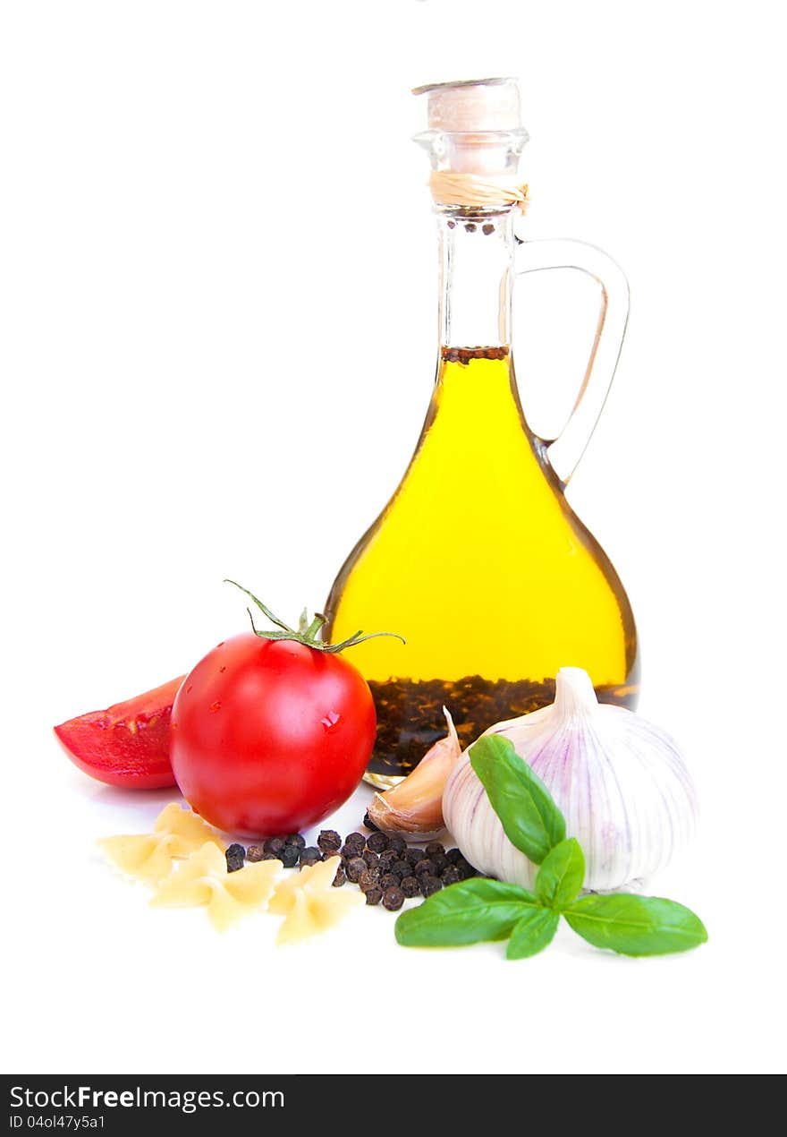 A bottle of olive oil with garlic, tomatoes and peppers. A bottle of olive oil with garlic, tomatoes and peppers.