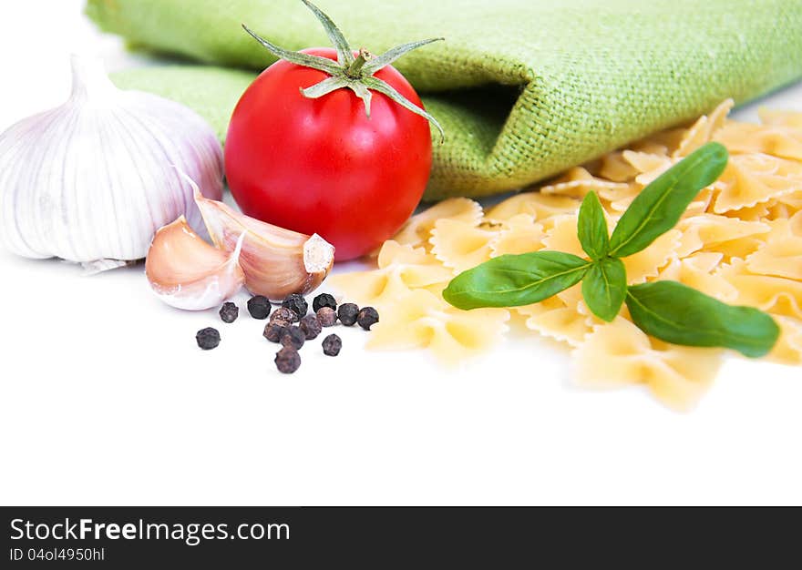 Pasta, spices and vegetables on a white background. Pasta, spices and vegetables on a white background