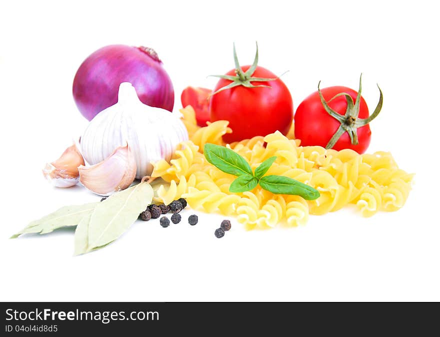 Pasta, spices and vegetables on a white background. Pasta, spices and vegetables on a white background