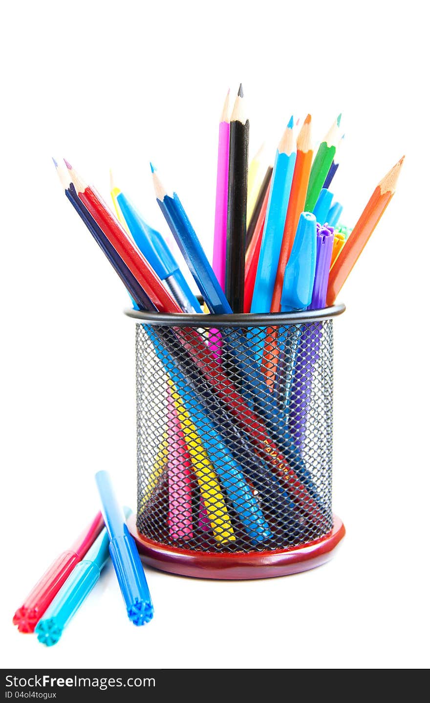 Color pencils and pens in metal vase on a white background