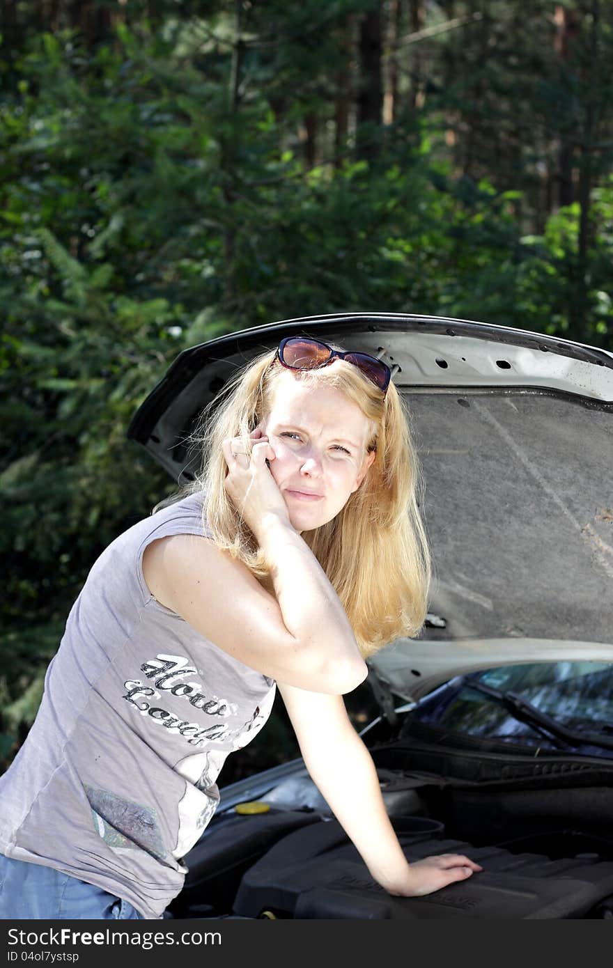 Woman calls for hepl - broken car on the road