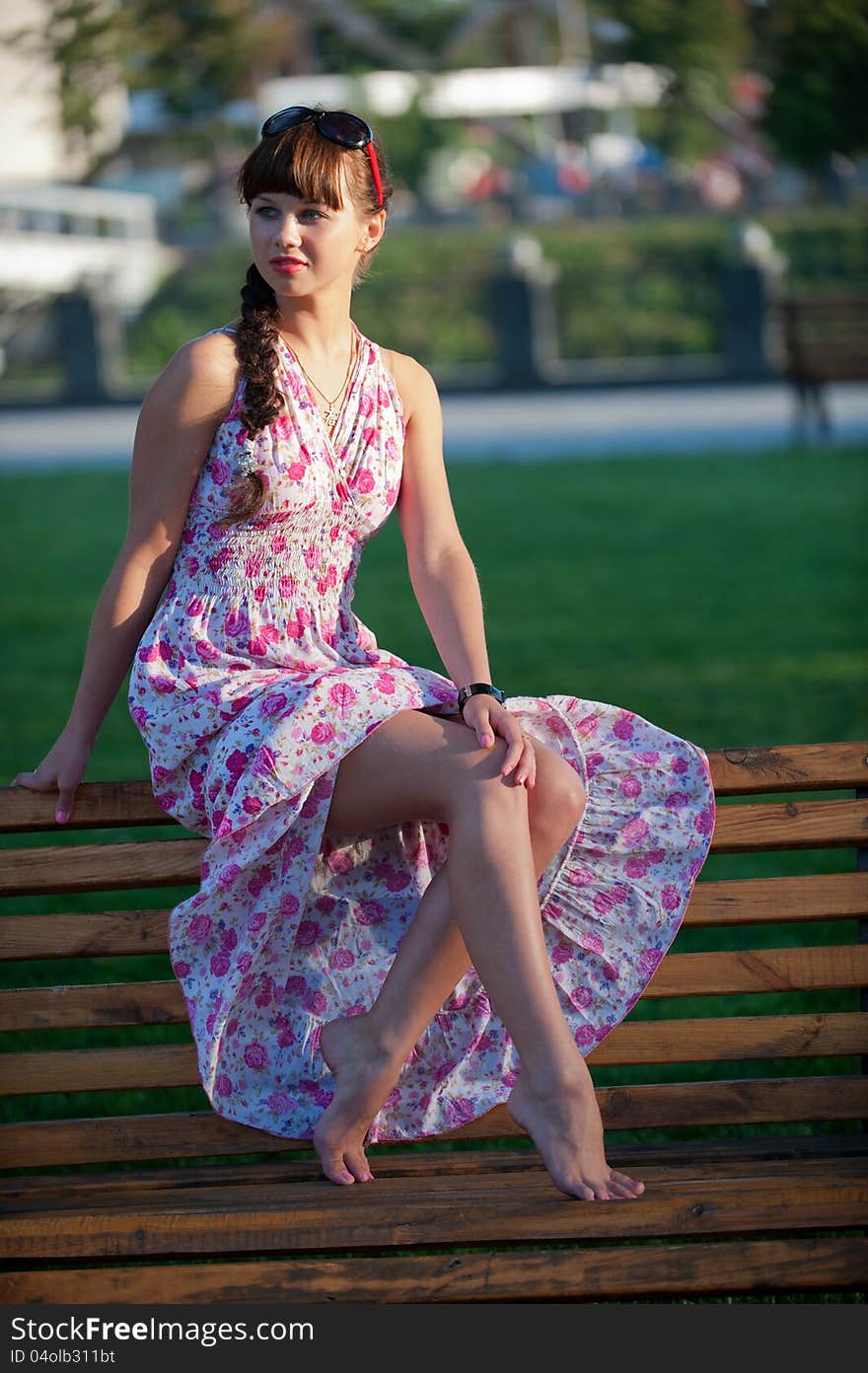 Picture a charming young girl posing in the park and shows her bare legs. Picture a charming young girl posing in the park and shows her bare legs