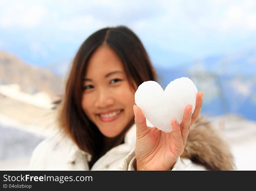 Asian woman holding a snowball