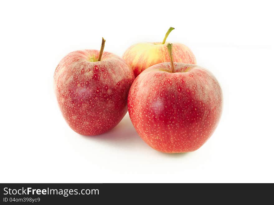 Three red apples on white background